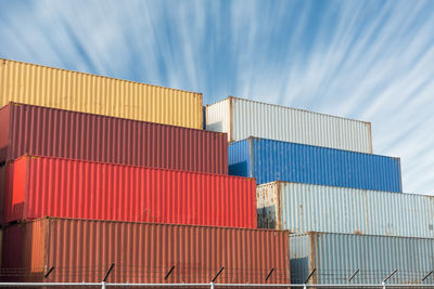 Stack of cargo containers against blue sky