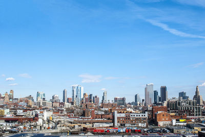 View of cityscape against blue sky