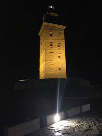 Low angle view of illuminated lamp at night