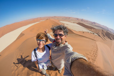 Portrait of smiling couple in desert