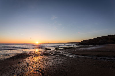 Scenic view of sea against sky at sunset