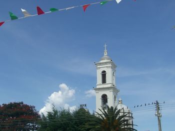 Low angle view of bell tower against sky