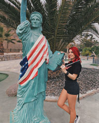 Woman standing by statue of liberty