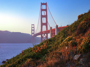 Bridge over river against sky during autumn