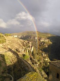 Rainbow over landscape against sky