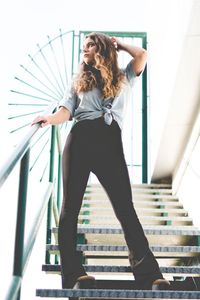 Low angle view of woman standing on staircase