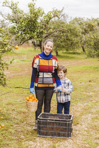 Portrait of smiling boy standing in basket