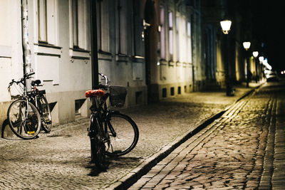 Bicycle parked on street by building