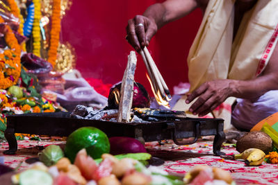 Midsection of man preparing food at market stall