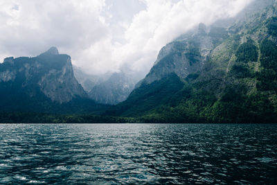 Scenic view of lake and mountains against sky