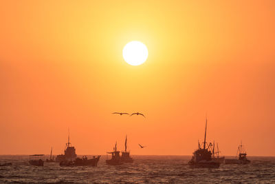 Scenic view of sea against orange sky