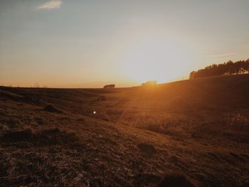 Scenic view of field against sky during sunset