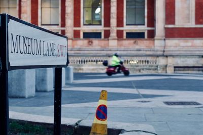 Road sign on street in city