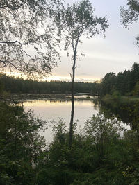 Scenic view of lake against sky at sunset