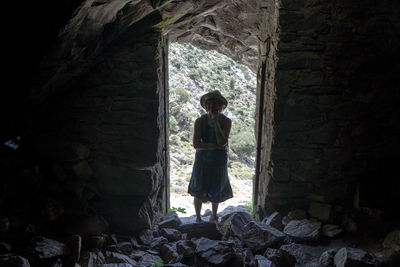 Full length of woman standing in cave