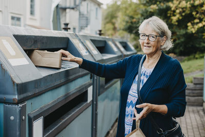 Woman recycling rubbish