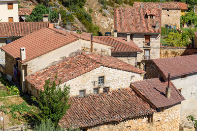 Background of old village houses with stone walls and red tile roofs.