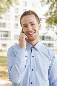 Portrait of young man standing outdoors