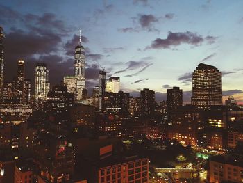 Illuminated cityscape against sky at night