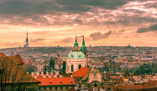 View of buildings in city at sunset