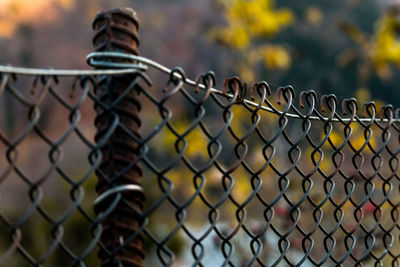 Close-up of chainlink fence against sky