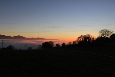 Scenic view of silhouette landscape against sky at sunset