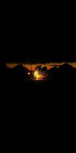 Silhouette landscape against sky at night