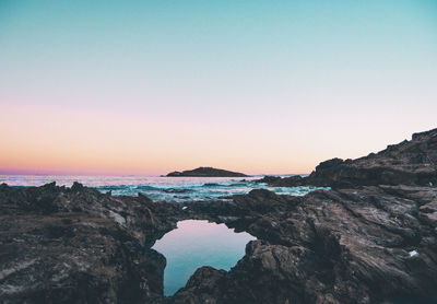 Scenic view of sea against clear sky during sunset