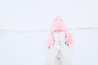 Woman standing against sky during winter