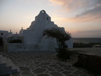 Built structure against cloudy sky at sunset