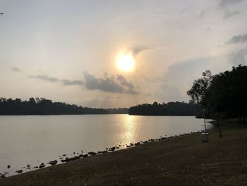 Scenic view of lake against sky during sunset