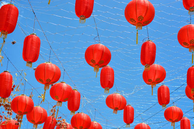 Low angle view of lanterns hanging against sky