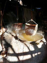 Clothes hanging on wicker basket on table