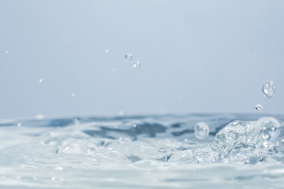 Close-up of water splashing against white background