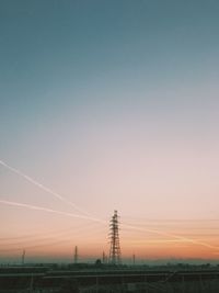 Electricity pylon against sky during sunset