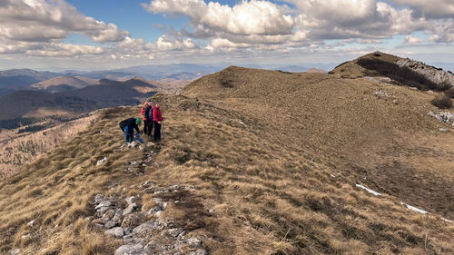 Small group of senior hikers on the mountain ridge