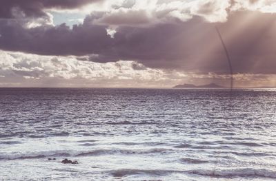 Scenic view of sea against cloudy sky