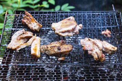 High angle view of meat on barbecue grill