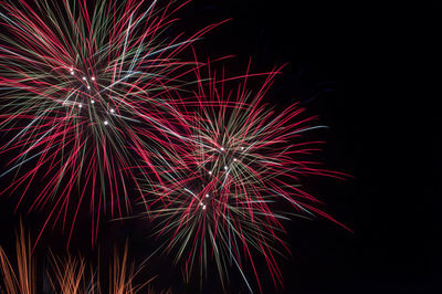 Low angle view of firework display at night