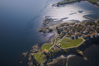 High angle view of sea and buildings on shore