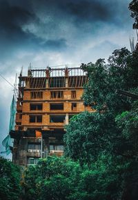 Low angle view of building under construction against sky