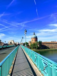 View of bridge over canal against blue sky