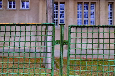 Metal fence against building