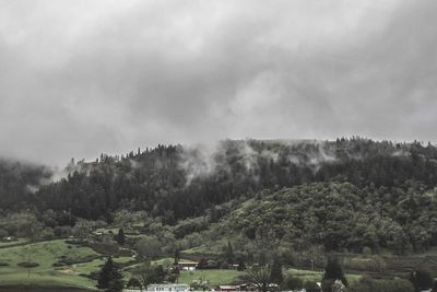 Scenic view of mountains against cloudy sky