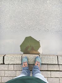 Low section of woman standing on tiled floor