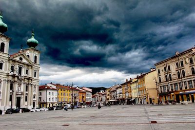 View of town square against cloudy sky