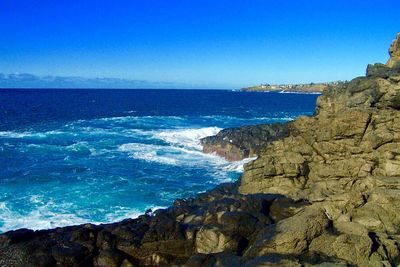 Scenic view of sea against clear blue sky