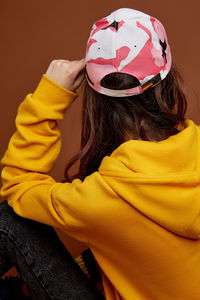 Rear view of woman with yellow hat