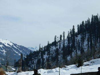 Scenic view of snow covered mountains against sky