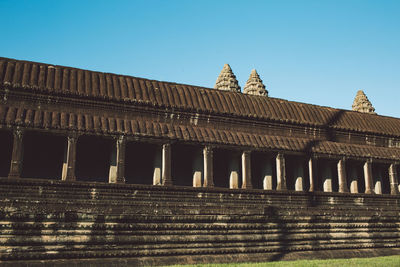 Low angle view of historical temple against clear blue sky